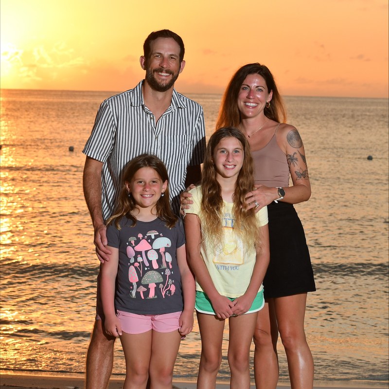 Ashly Jenkins, White Coat captioner, with her family on the beach at sunset
